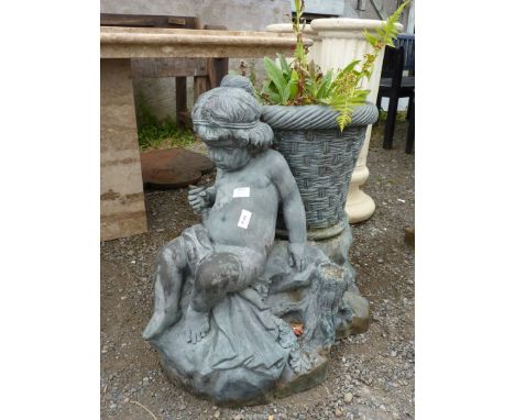 A metal planter with small child sitting on a log, 26" tall.