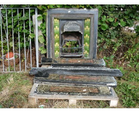 An open fire grate with Art Nouveau design glazed tiles and a quantity of slate/marble surround, 38" wide x 38".