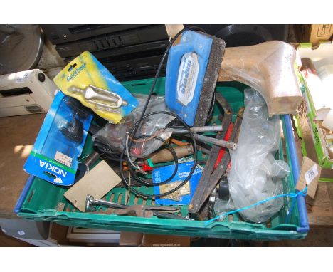 A crate of hinges and various tools.