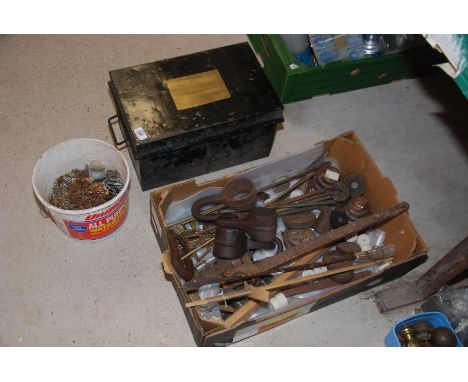 A number of brass stair rods, large stilsons and weights and a metal trunk.