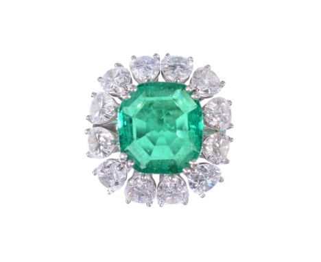 An emerald and diamond cluster ring, the square shaped emerald with canted...  An emerald and diamond cluster ring,   the squ
