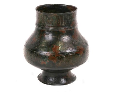 An early Islamic silver inlaid bronze vessel decorated with bands of foliate medallions within borders of calligraphy, 16.5cm