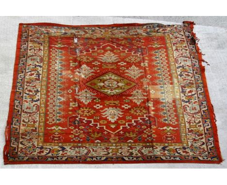 A large Turkish hand knotted woollen Ushak carpet with repeated geometric pattern 579 by 366cms (19ft 10 by 12ft 6ins).