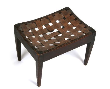 An Arts &amp; Crafts oak stool by Arthur Simpson of Kendall, with lattice work leather seat, 40cms (15.5ins) wide.