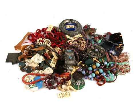 A quantity of ethnic and similar costume jewellery to include jade type beads and necklaces.