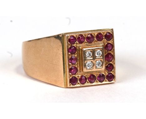 A large 9ct gold gentleman's ring set with four diamonds surrounded by rubies, approx UK size 'W'. 13g