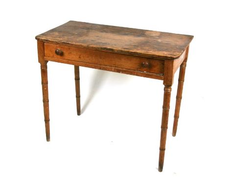A late 19th century pine side table with single frieze drawer, on faux bamboo legs, 84cms (33ins) wide.Condition ReportSplit 