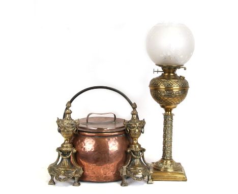 A Victorian brass oil lamp with opaque glass shade, 50cms (20ins) high; together with a pair of brass fire dogs and a lidded 