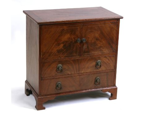 A George III style mahogany commode chest of small proportions with two panelled doors above two drawers, on bracket feet, 63