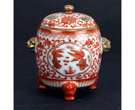 A Japanese kutani porcelain tripod censer and cover with mask handles and painted decoration, four character mark to base, 11