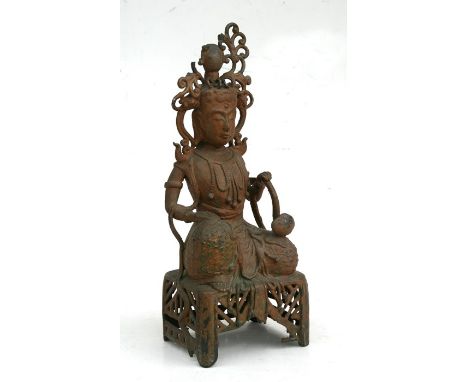 A Chinese gilded metal Buddha figure kneeling on a pierced stool and holding a sceptre, 30cms (12ins) high.