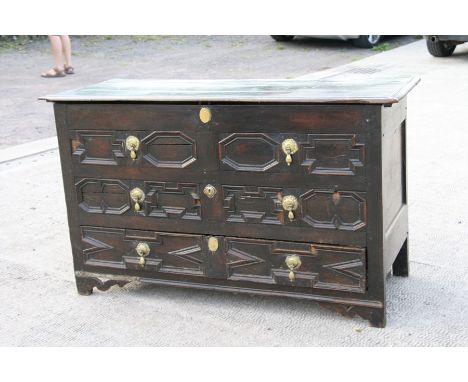 An 18th / 19th century oak mule chest, the hinged top above two dummy drawers with a further long drawer beneath, on bracket 