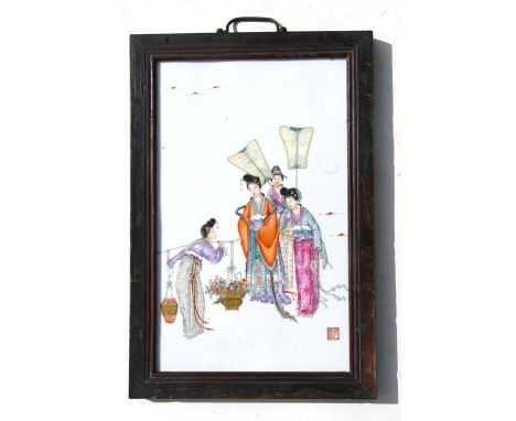 A Chinese porcelain panel depicting robed ladies and their attendants, with red seal mark lower right, framed, 25 by 40cms (9