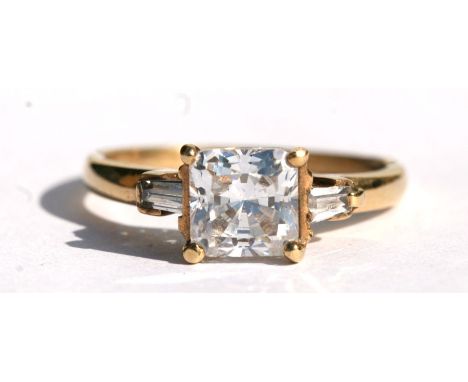 A 9ct gold ring set with a square white stone flanked by two baguette cut white stones, approx UK size 'L'.