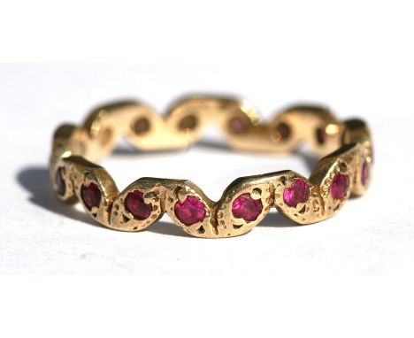 A 9ct gold ruby set eternity ring, approx UK size 'L'.