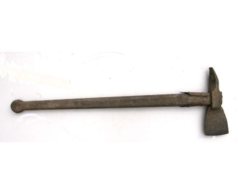 An iron axe head on a wooden shaft.