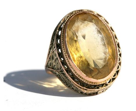 A citrine and yellow coloured metal ring, approx UK size 'N'.