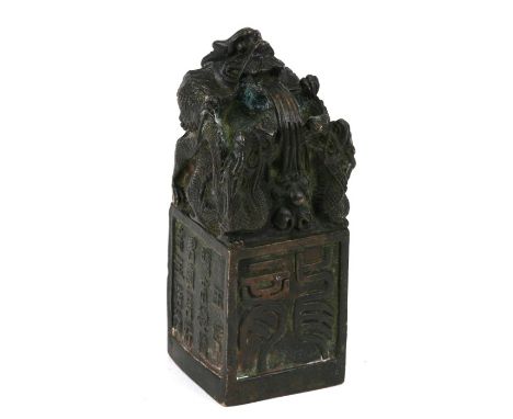 A Chinese bronze seal, the top with a mythical beast, on a square platform with character marks, poem and calligraphy to all 