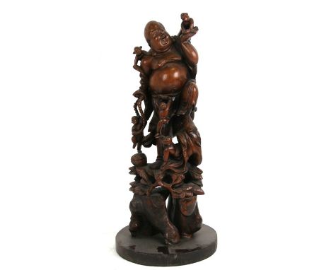 A Chinese rootwood carving depicting a happy Buddha with a group of children playing on him, 51cms (20ins) high; together wit