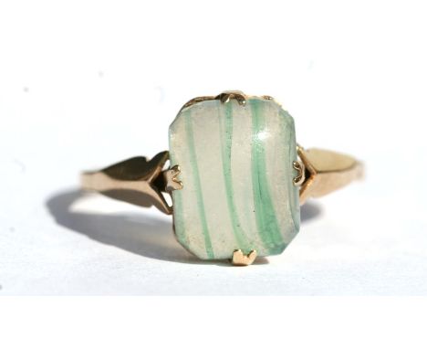 A 9ct gold dress ring set with a rectangular green stone, approx UK size 'M'.