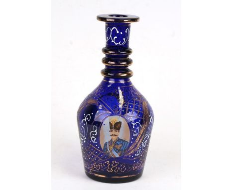 A Bohemian blue glass decanter with enamel and gilt decoration, with printed portraits of Mozaffar ad-Din Shah Qajar, 29cms (