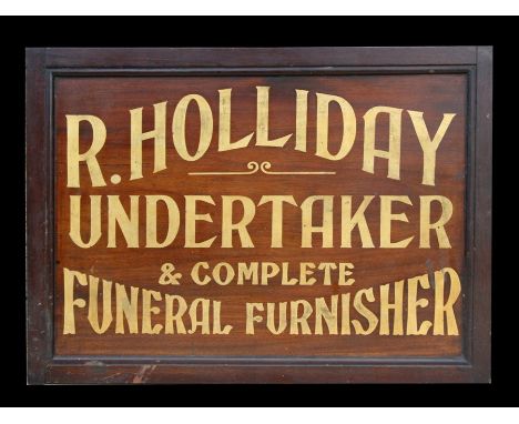 A contemporary sign 'R Holliday Undertaker &amp; Complete Funeral Furniture', 55cms (21.25ins) wide.