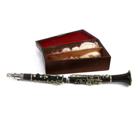 A rosewood 'E' flat clarinet, in a mahogany box.