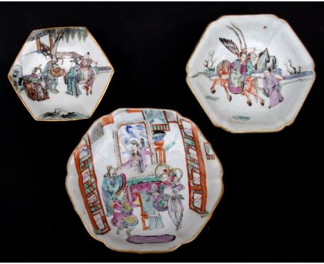 A group of three Chinese famille rose dishes on stands decorated with figures, each with red seal mark to the underside, the 