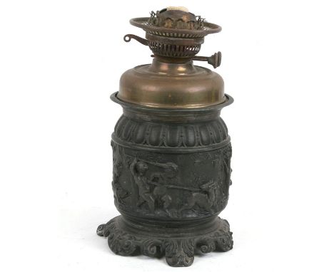 A Victorian spelter oil lamp decorated with cherubs, 29cms (11.5ins) high.