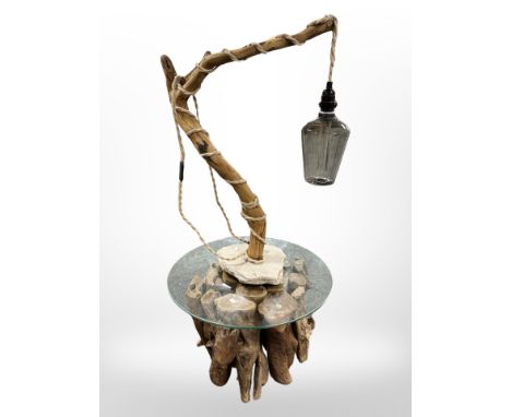 A contemporary driftwood glass topped occasional table, diameter 60 cm together with matching lamp 