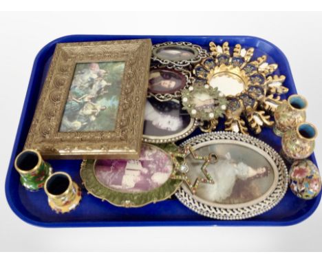 A group of decorative picture frames, gilt sunburst mirror, two small pairs of enamel vases etc 