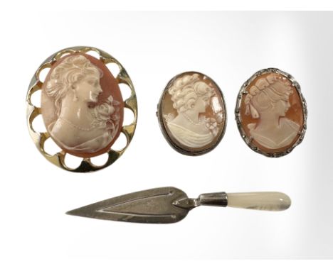 Two silver cameo brooches, a further gilt example and a silver and mother of pearl trowel bookmark