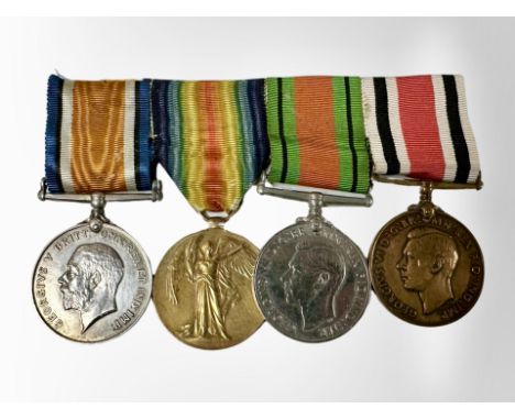 A First and Second World War medal group including a British war medal and victory medal named to M2-203128 Pte. H.M. Nixon A