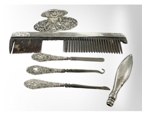 A small group of silver items including comb, button-hooks, nail buffer handle etc