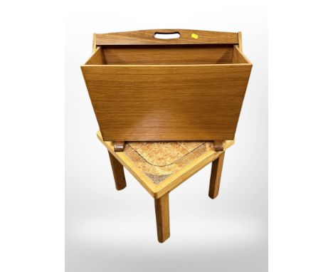 A 1970's teak magazine rack with swing handle, width 54 cm together with a tiled inset lamp table 