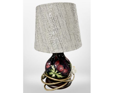 A Moorcroft table lamp with shade, overall height 32cm.