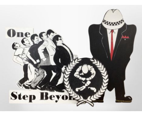 A painted sign "one step beyond" together with two others 