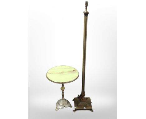 An onyx circular occasional table and a brass standard lamp 