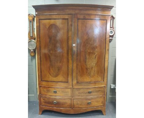 An Edwardian mahogany bow front double wardrobe, 211 x 149 x 60cmWear commensurate with age and use. Cracking and chipping to