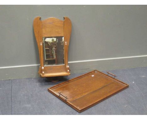 An Arts &amp; Crafts oak wall mirror with shelf above, together with an early 20th century oak galleried tray