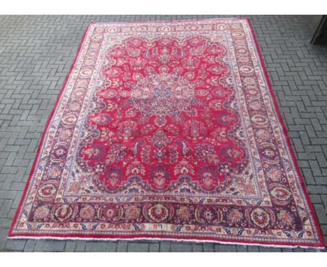 A Qashqai carpet of typical design with a warm russet field, 390 x 305cm