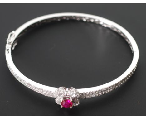 DIAMOND AND RUBY SET 18CT WHITE GOLD HINGE OPENING BANGLE, set with 34 baguette cut diamonds and 112 melee diamonds, the top 
