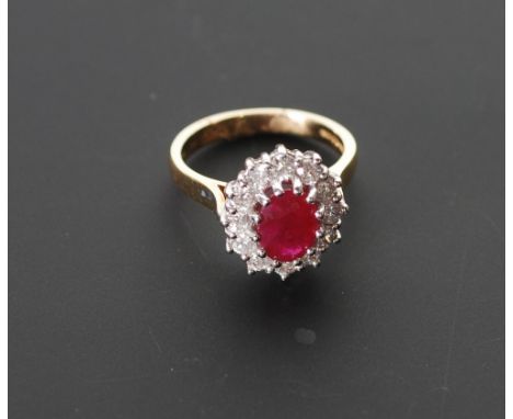 18CT GOLD RUBY AND DIAMOND CLUSTER RING, oval cut ruby with twelve stone diamond surround, 0.60ct approx. total estimated car