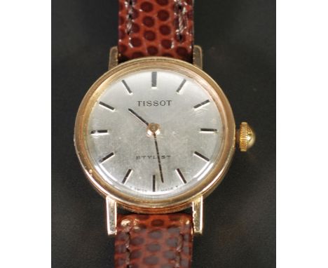 LADY'S TISSOT STYLIST 9CT GOLD CASED WRIST WATCH, 17 jewel movement, silvered dial with batons, on brown leather strap, Birmi