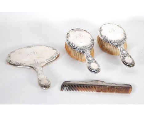 GEORGE V EMBOSSED SILVER CLAD DRESS TABLE HAND MIRROR, with oval plate, Chester 1911, TOGETHER WITH A SIMILAR PAIR OF HAIR BR