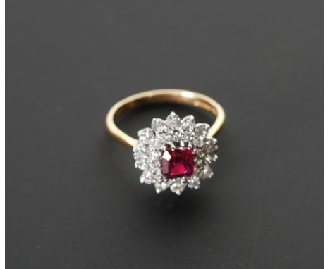 18CT GOLD RUBY AND DIAMOND CLUSTER RING, cushion cut central sapphire with twenty eight stone diamond set two tier surround, 