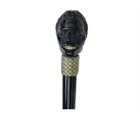 EARLY 20TH CENTURY EBONY WALKING CANE, with carved finial modelled as the head of a man, bone teeth, 92cm long