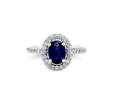 A Sapphire &amp; Diamond Ring, made of 18ct White Gold. Featuring a Oval Cut Blue Sapphire in a 4 claw setting, estimated 0.9