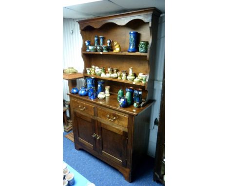 A mid 20thC oak Welsh Dresser, on bracket feet.
