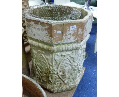 A large stone octagonal Planter, with moulded floral decoration.
